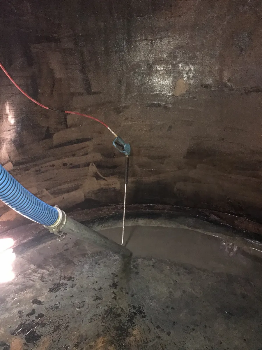 Inside a water tank during a professional pressure clean