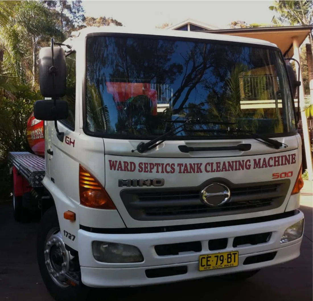 Ward vacuum truck parked kerbside with hose run out